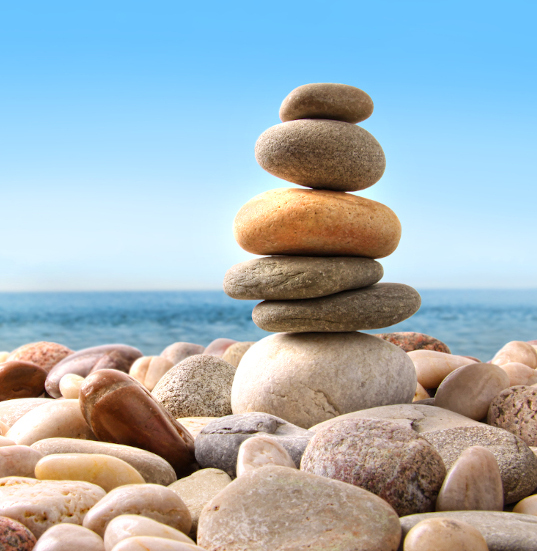 Stack of pebble stones on white